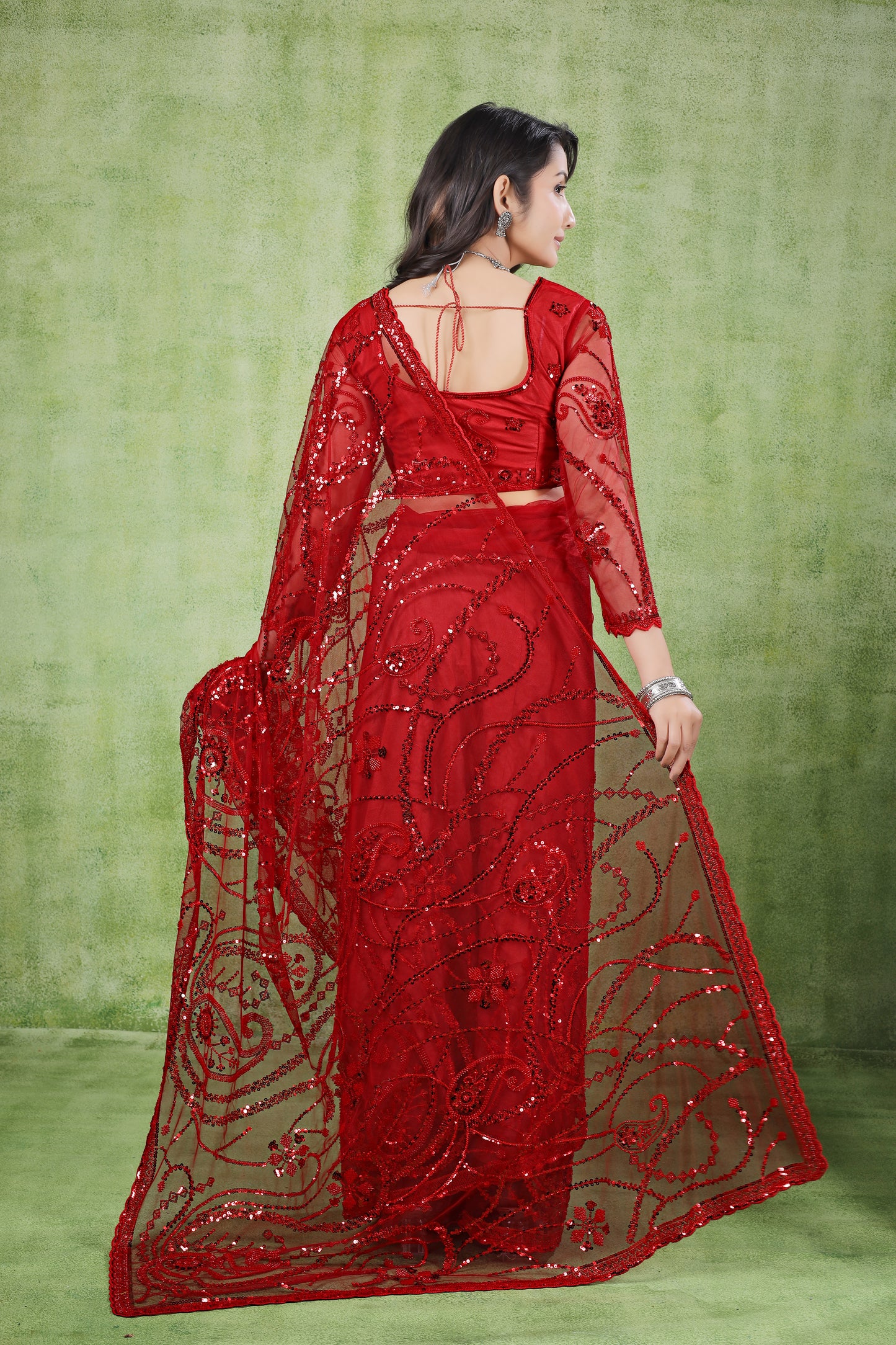 Red Kanyaari saree with cutdana embellishments and matching unstitched blouse, draped elegantly on a mannequin.