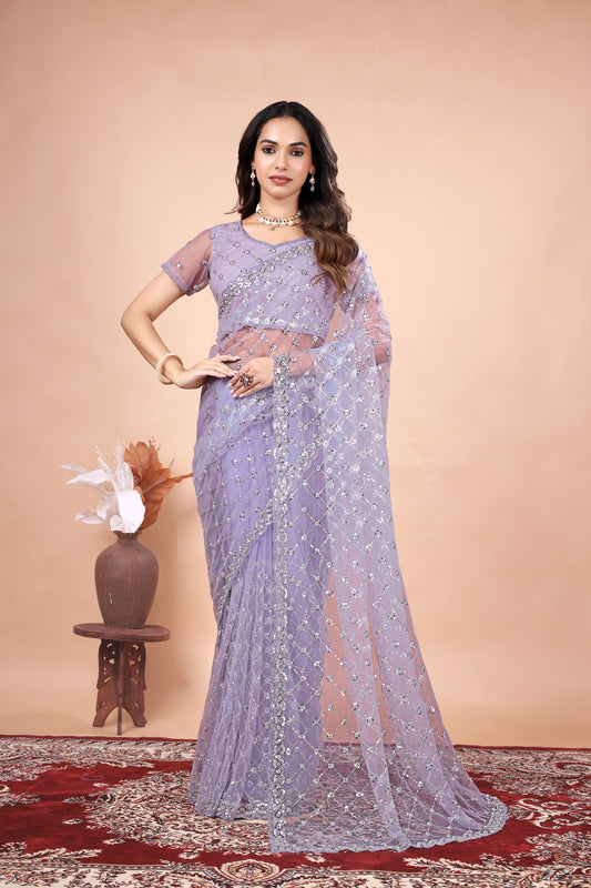 Green net saree with cutdana work by Kanyaari, featuring intricate embroidery and elegant drape.