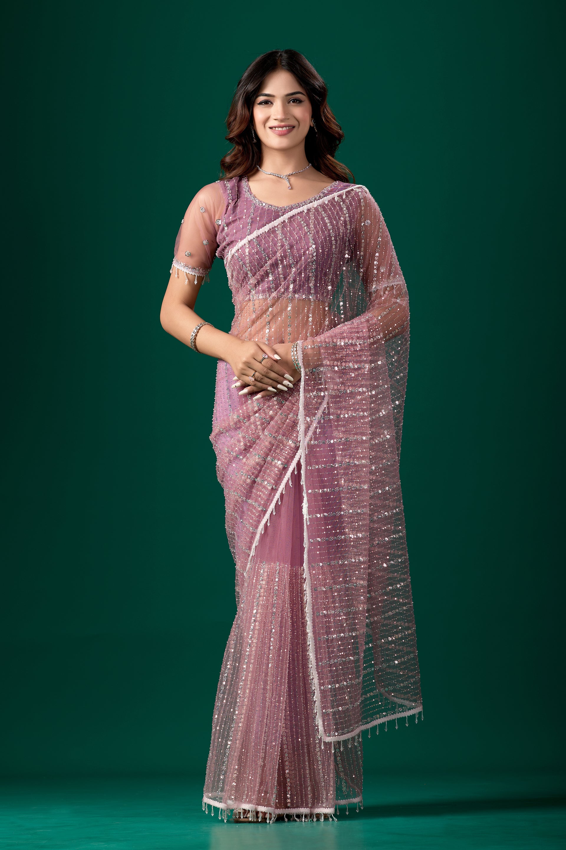 Purple net saree with cutdana work and latkan detailing, paired with an unstitched blouse from Kanyaari.