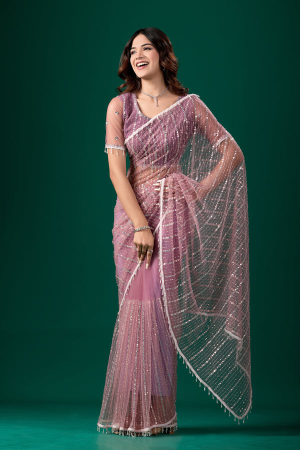 Purple net saree with cutdana work from Kanyaari, featuring intricate embroidery and an unstitched blouse for elegant traditional wear.