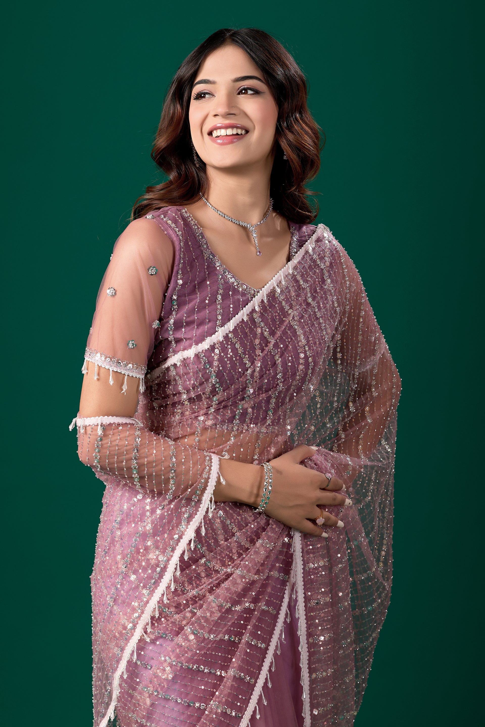 Purple net saree with cutdana work from Kanyaari, featuring a traditional design and an unstitched blouse.
