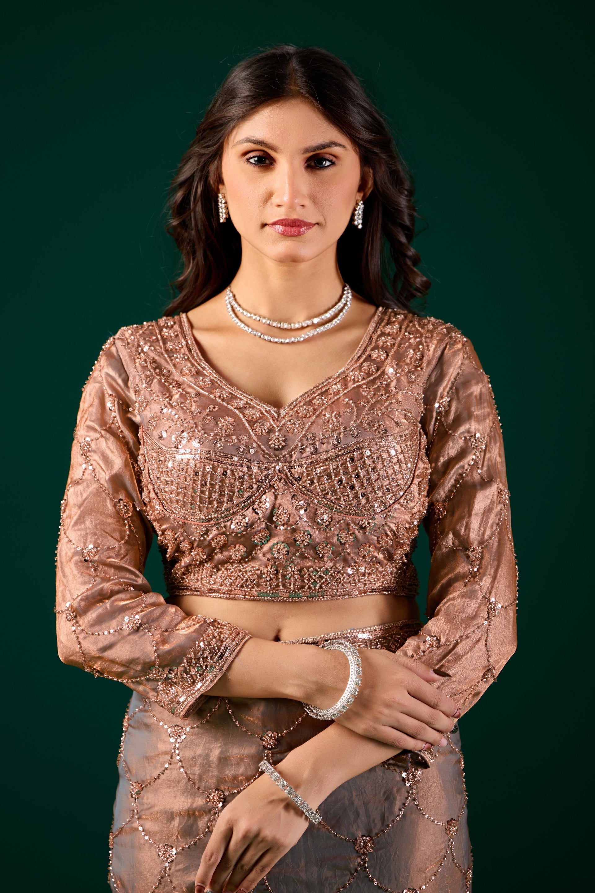 Luxury silk saree with rose gold cutdana work by Kanyaari, featuring intricate gold embroidery and elegant draping.