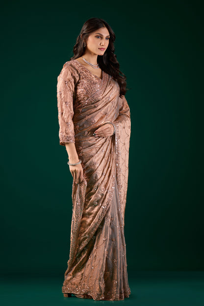 Elegant silk saree with rose gold cutdana work by Kanyaari, showcasing intricate gold embroidery and luxurious fabric.