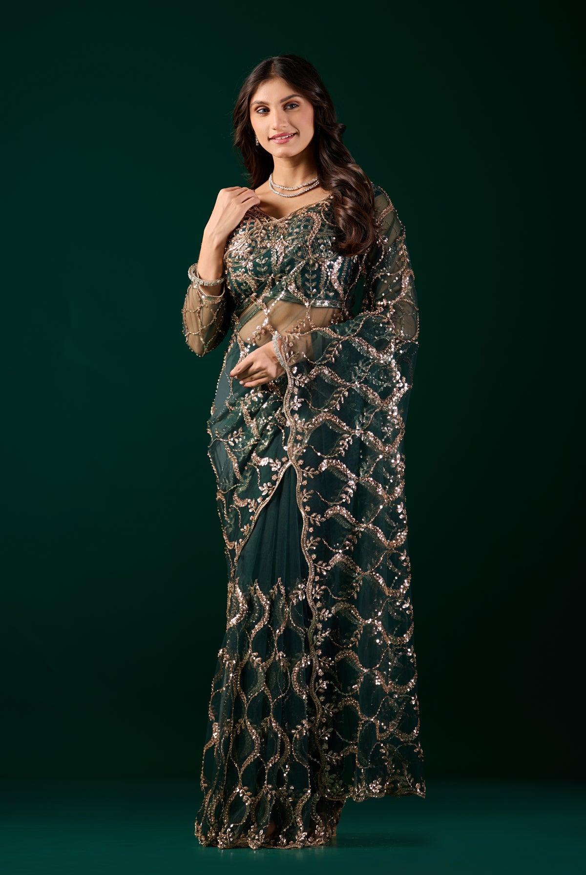 Green net saree by Kanyaari with heavy cutdana work border, showcasing intricate embroidery and elegant fabric details.