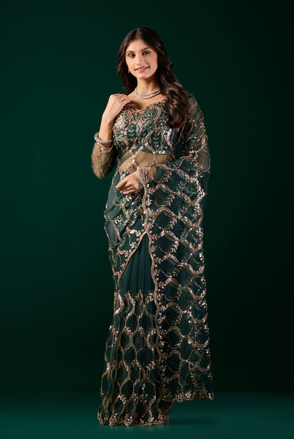 Green net saree by Kanyaari with heavy cutdana work border, showcasing intricate embroidery and elegant fabric details.