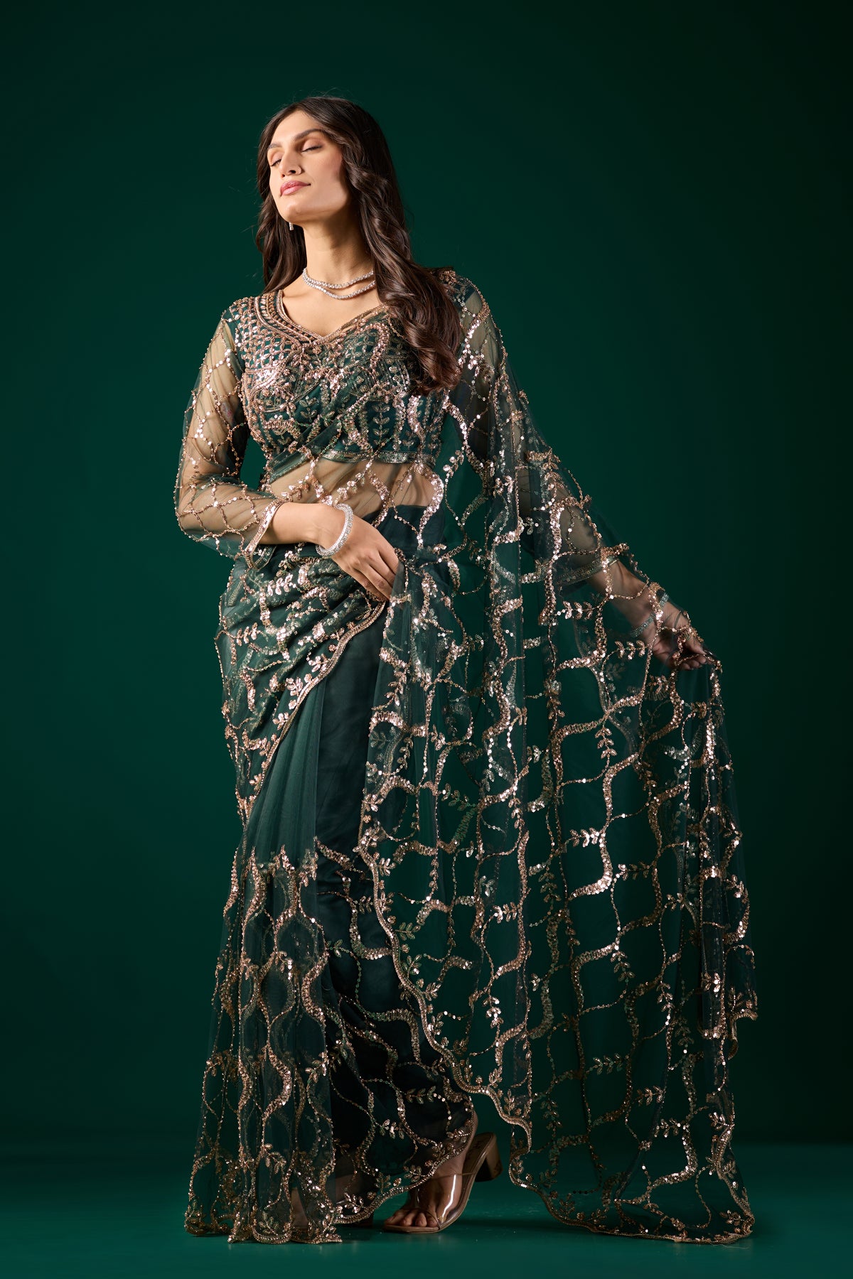 Green net saree with heavy cutdana work border by Kanyaari, showcasing intricate embroidery and elegant drape.