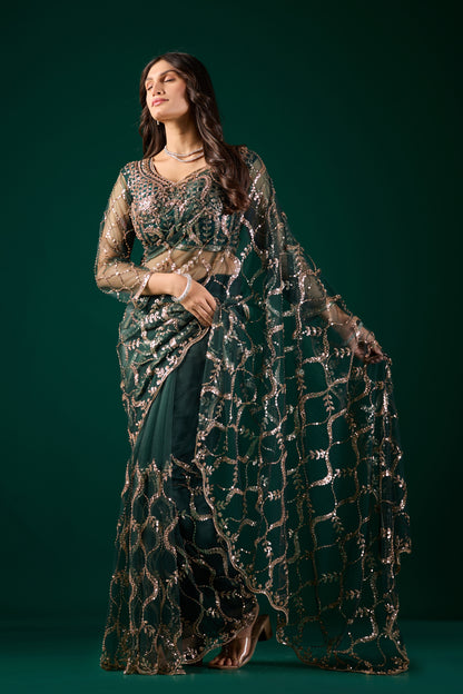 Green net saree with heavy cutdana work border by Kanyaari, showcasing intricate embroidery and elegant drape.