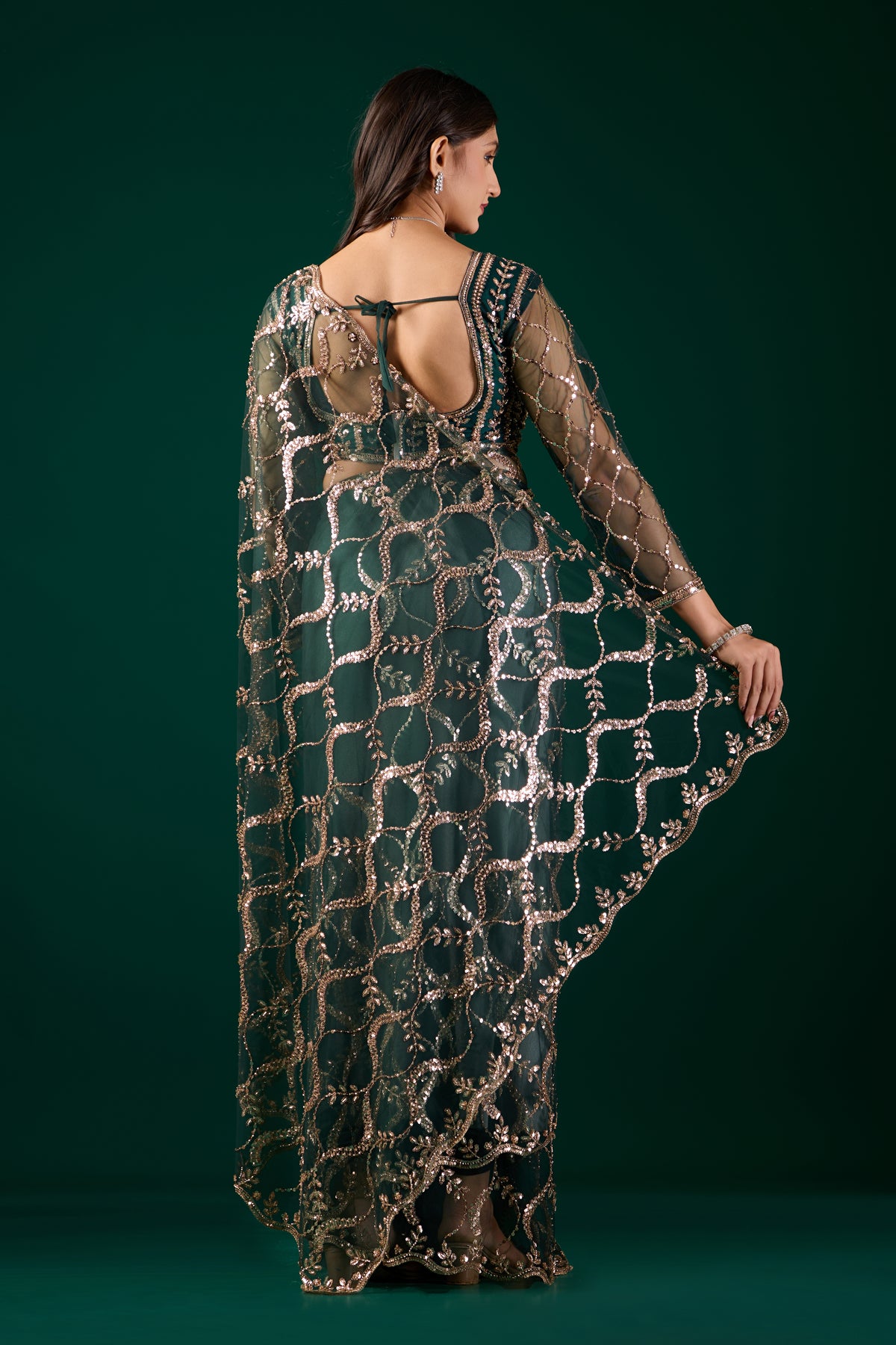 Kanyaari green net saree with heavy cutdana work border, showcasing intricate embroidery and elegant drape.