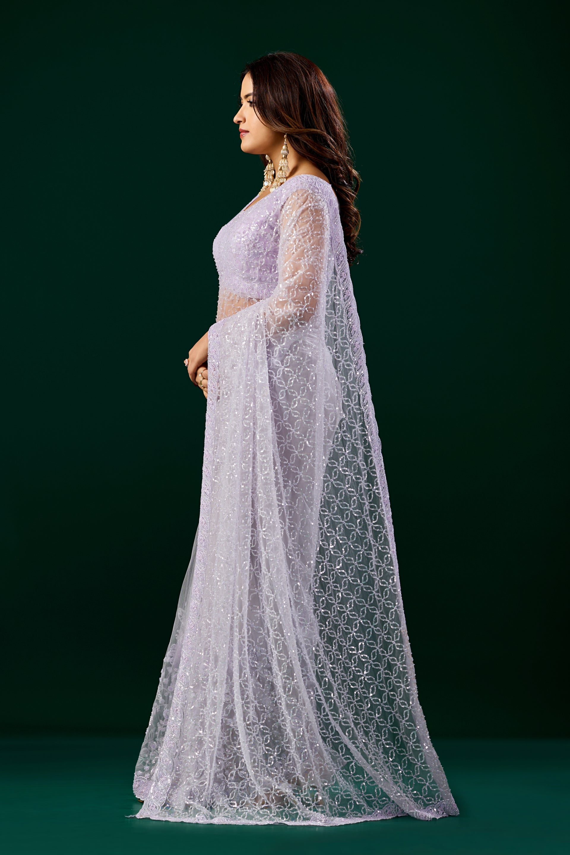 Elegant purple saree with heavy cutdana embroidery and net fabric by Kanyaari, worn with intricate detailing and traditional style.