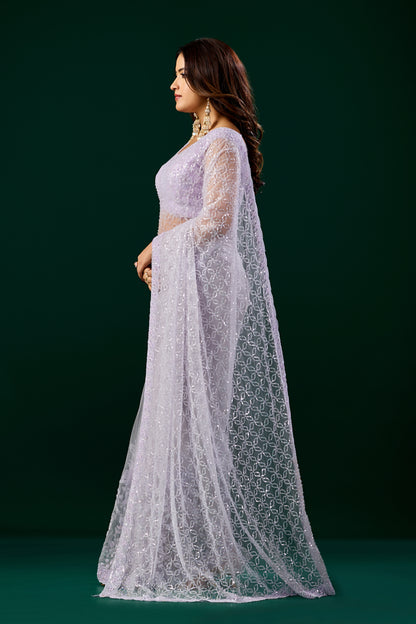 Elegant purple saree with heavy cutdana embroidery and net fabric by Kanyaari, worn with intricate detailing and traditional style.