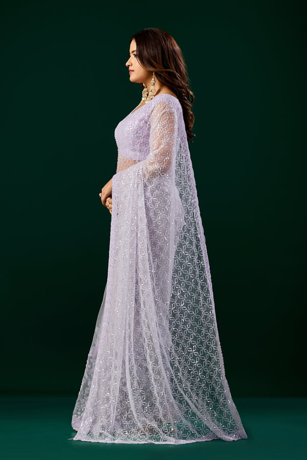 Elegant purple saree with heavy cutdana embroidery and net fabric by Kanyaari, worn with intricate detailing and traditional style.
