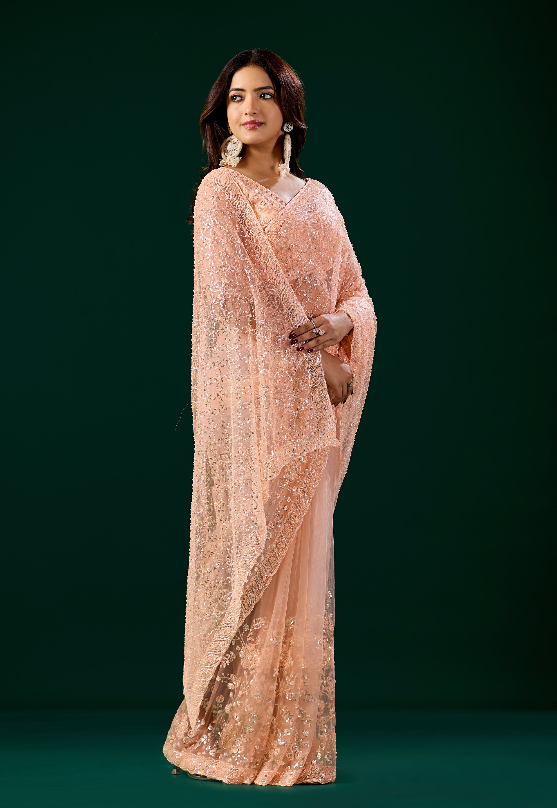 Orange embroidered saree with heavy cutdana work, stylish net fabric and intricate embroidery by Kanyaari Deepika collection.
