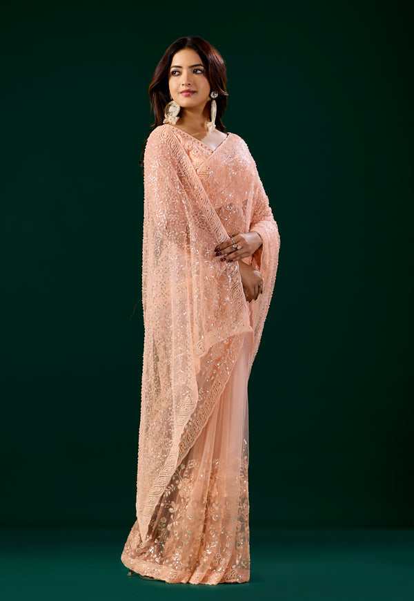 Orange embroidered saree with heavy cutdana work, stylish net fabric and intricate embroidery by Kanyaari Deepika collection.