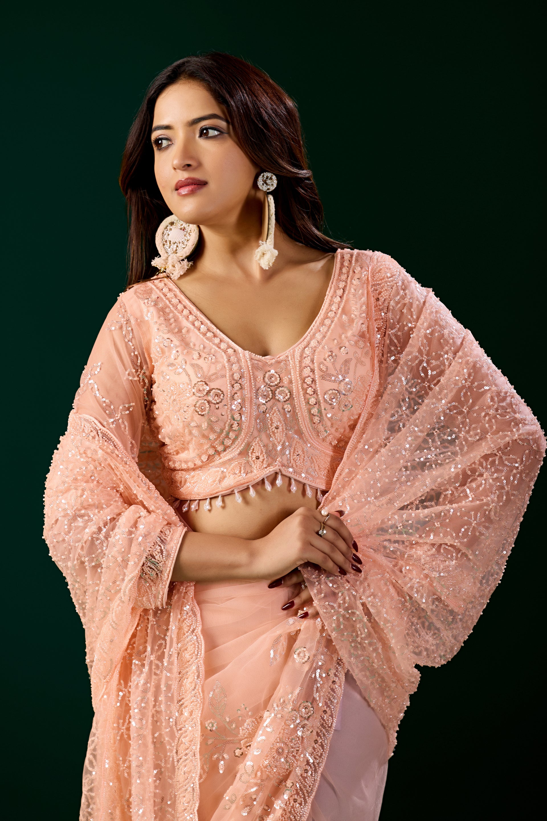 Kanyaari Styalish Net orange saree with heavy cutdana embroidery, featuring intricate traditional design and vibrant color.