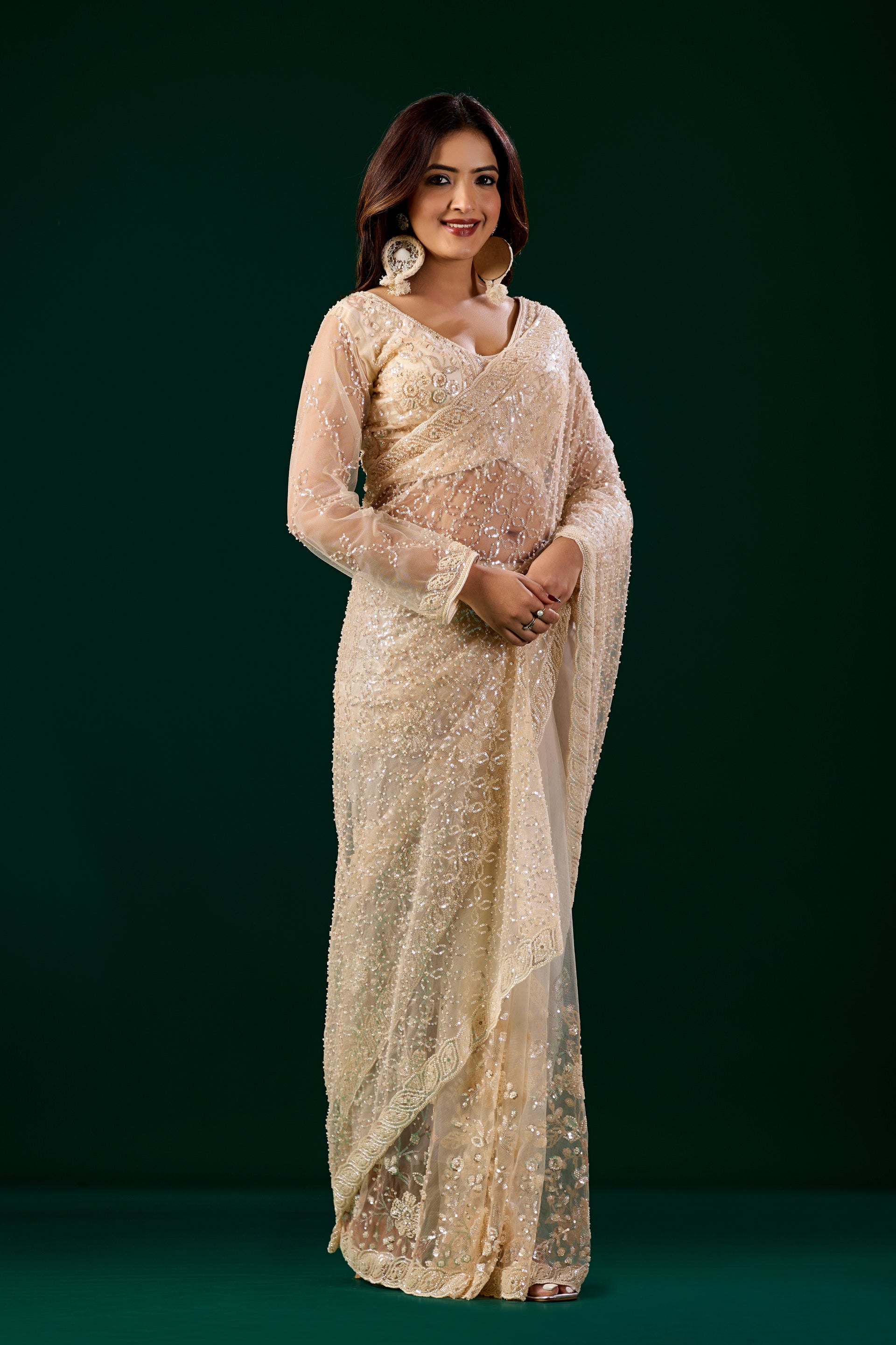 Cream embroidered saree with heavy cutdana work, stylish net fabric by Kanyaari, featuring intricate embroidery and elegant design.