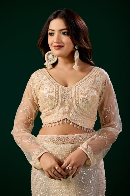 Cream Kanyaari saree with heavy cutdana embroidery and net fabric, featuring intricate design and elegant drape.