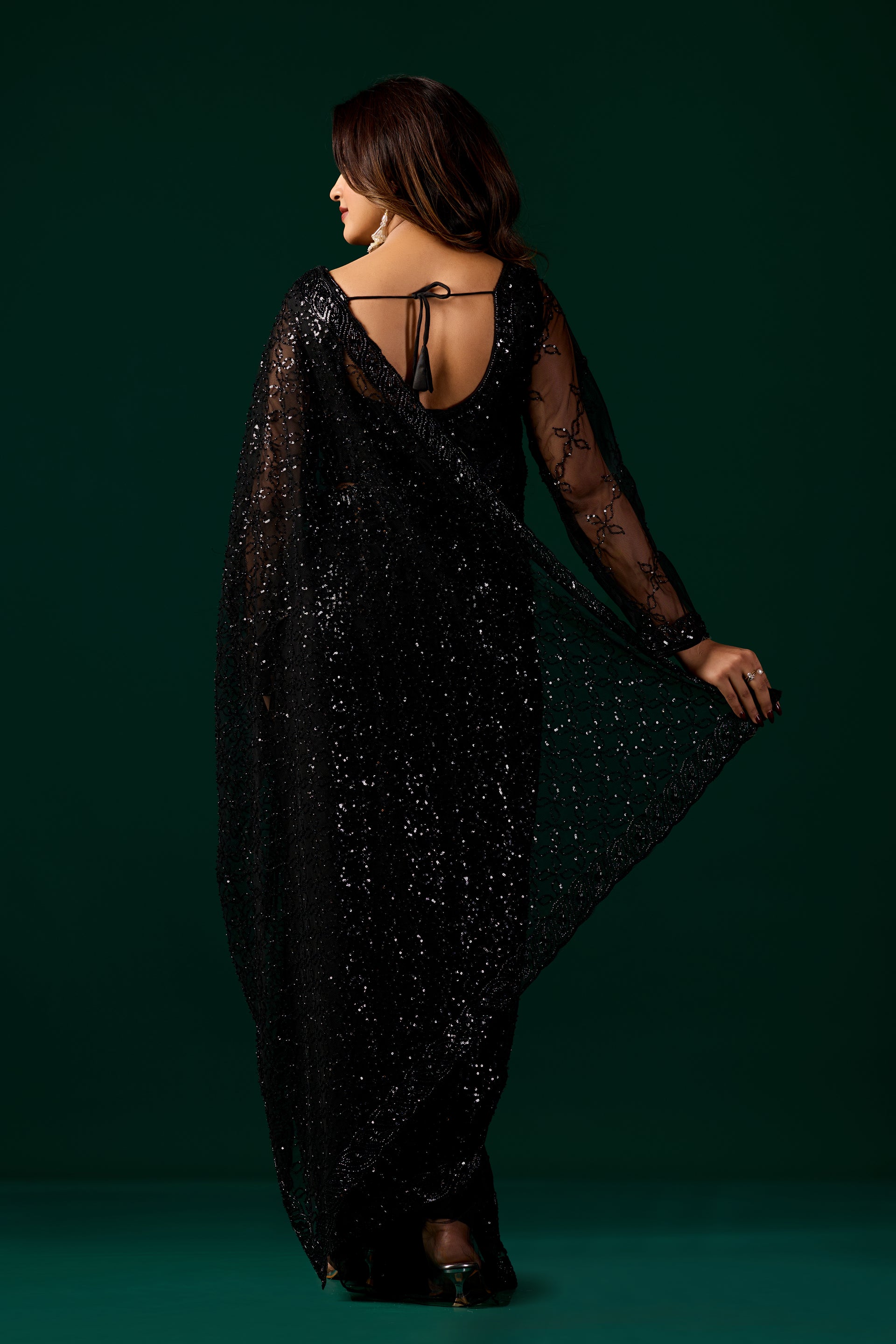 Kanyaari black net saree with intricate handwork and unstitched blouse, showcasing detailed embroidery and elegant drape.