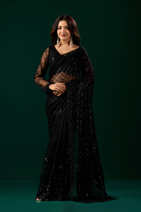Kanyaari black net saree with intricate handwork, paired with unstitched blouse for traditional Indian attire.