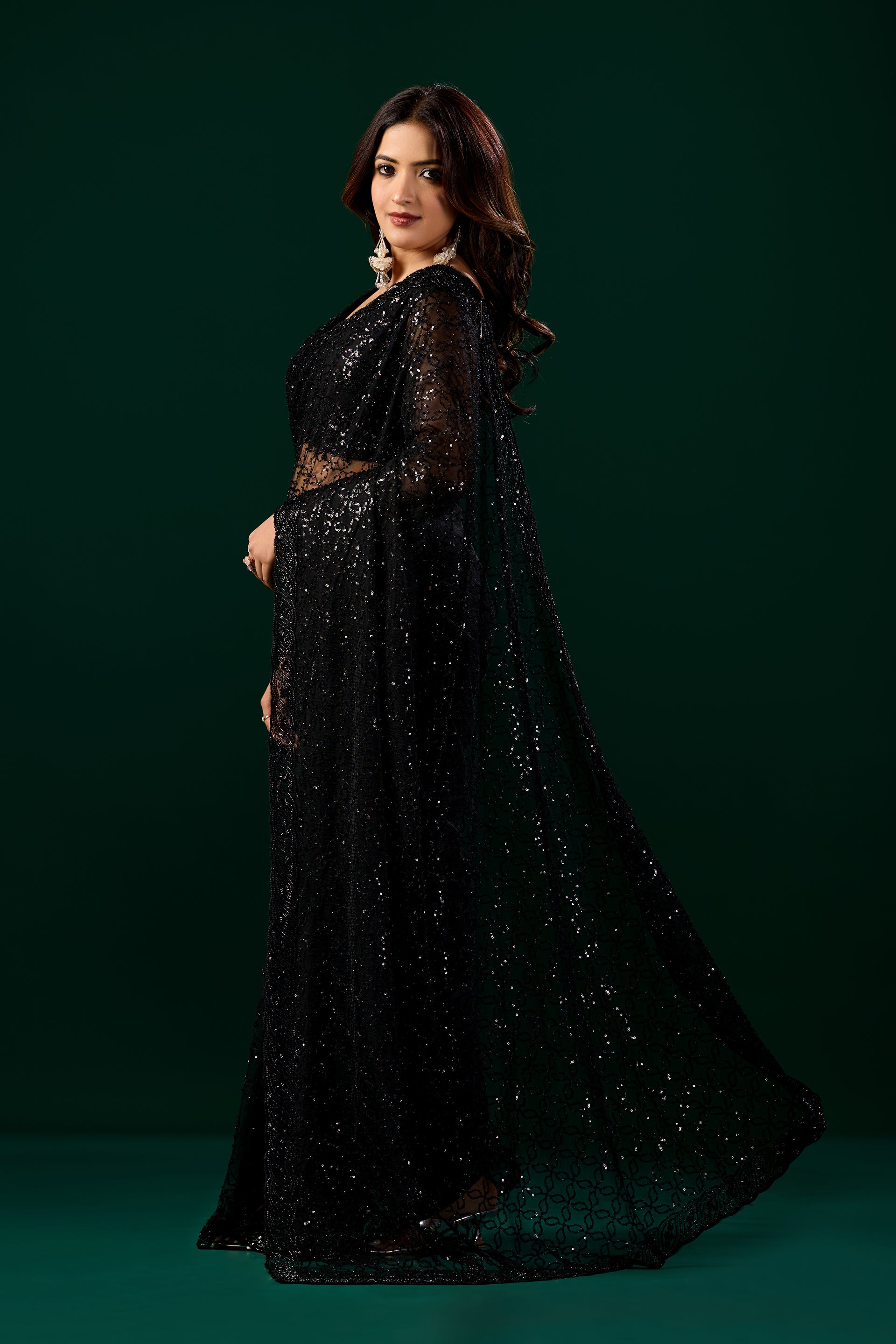 Kanyaari black net handwork saree with intricate embroidery and unstitched blouse, draped elegantly on a model.
