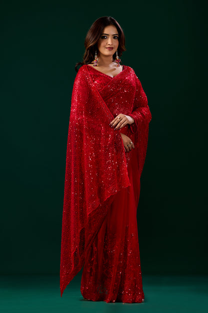 Red Kanyaari saree with cutdana embellishments and unstitched blouse, showcasing intricate embroidery and vibrant fabric.