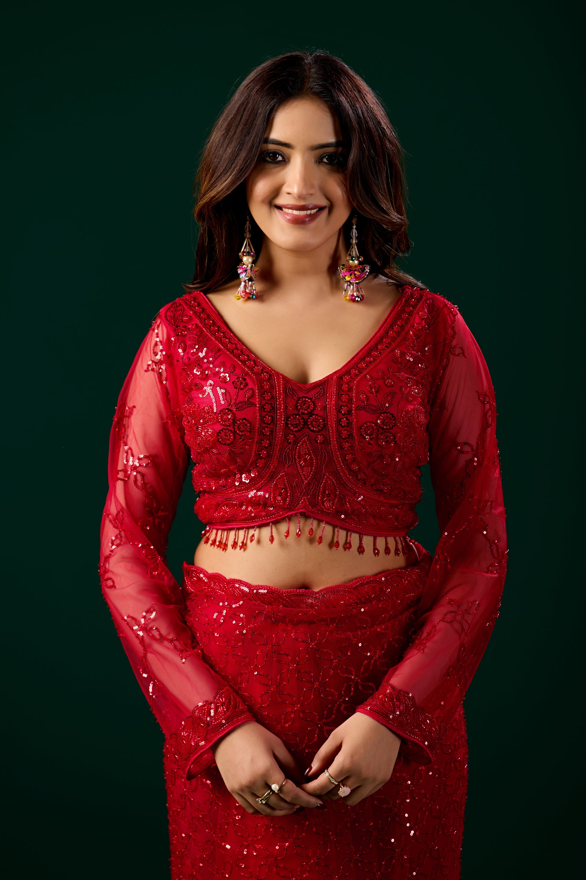 Red Kanyaari saree with cutdana embellishments and matching unstitched blouse, traditional Indian attire on display.