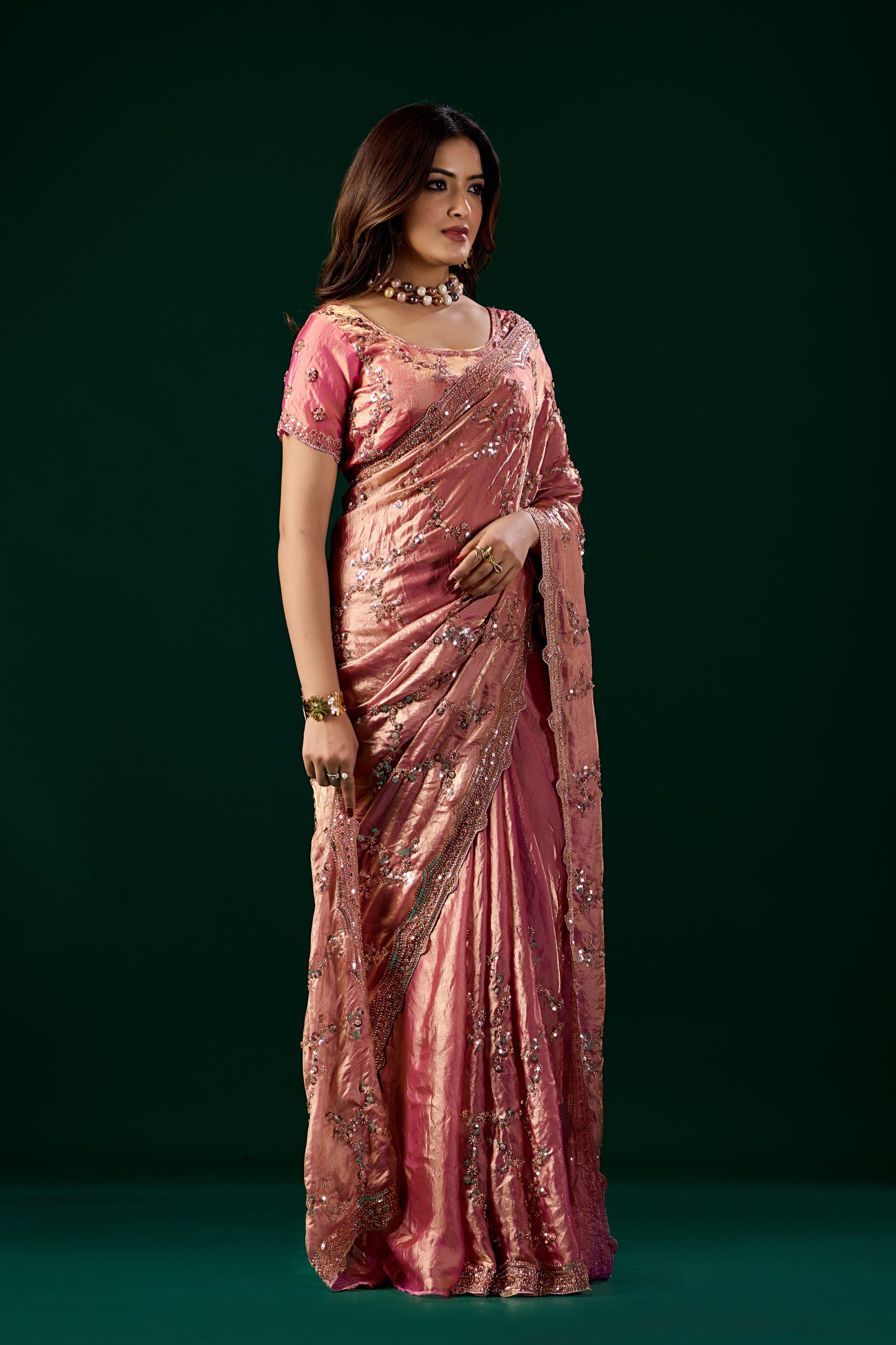 Kanyaari premium pink silk saree featuring intricate rose gold cutdana work and elegant draping.