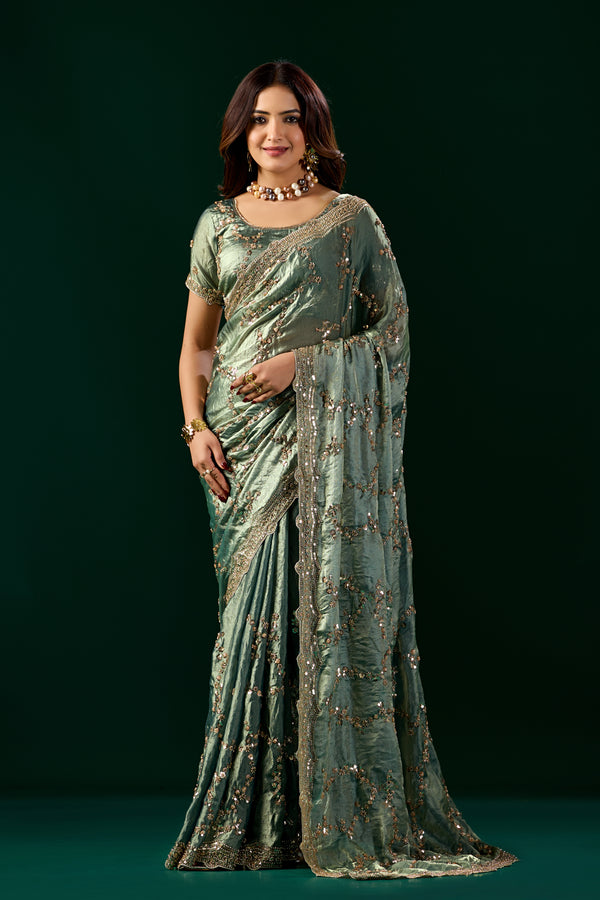 Kanyaari premium green silk saree with rose gold cutdana work, elegant nakhrali design and intricate detailing.