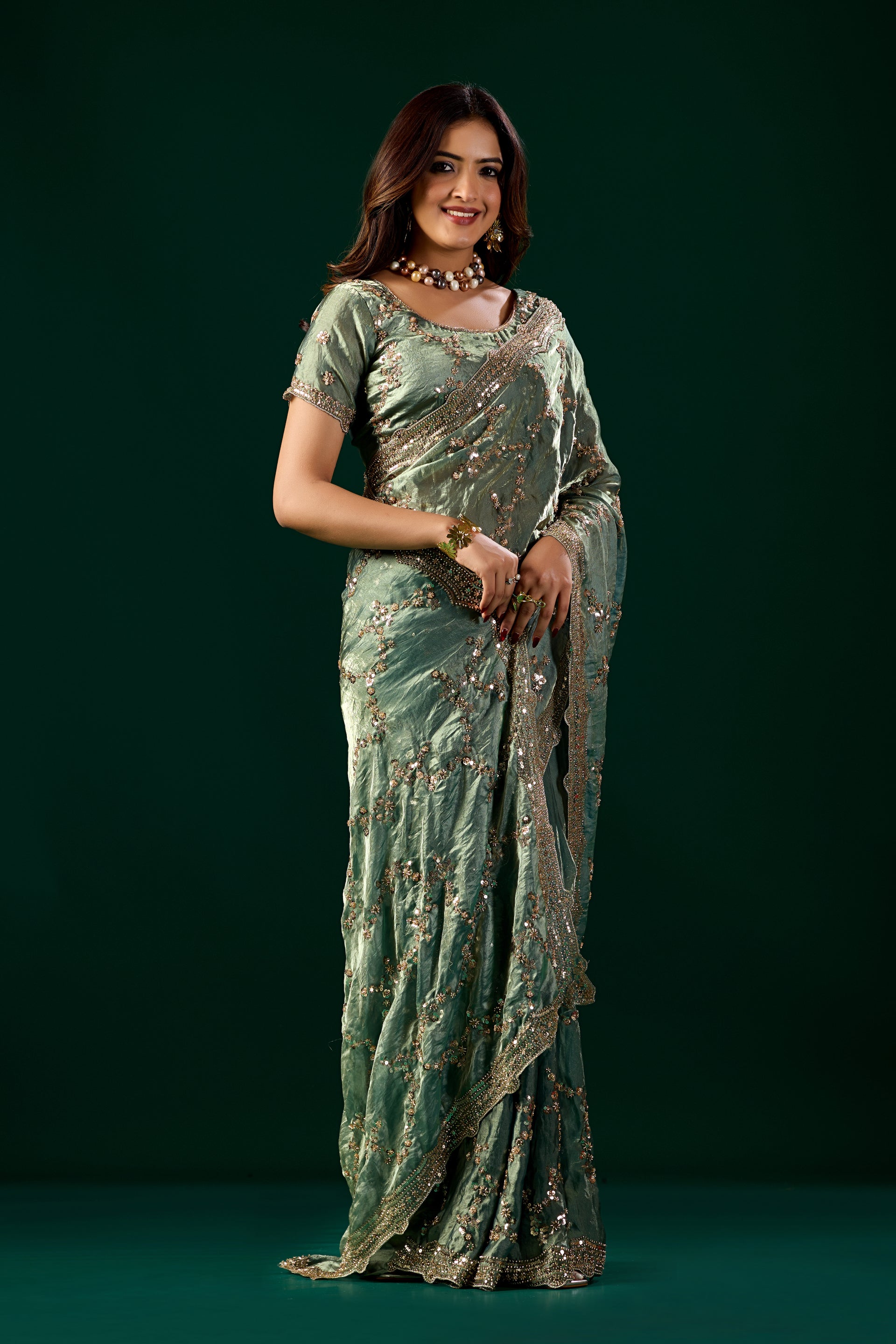Kanyaari premium silk bottle green saree with rose gold cutdana work, elegant traditional Indian attire.