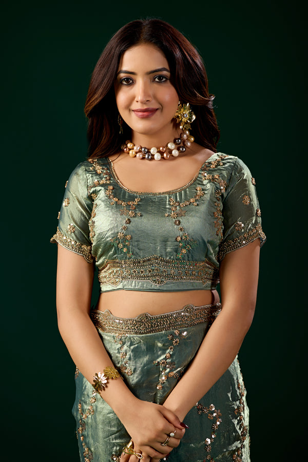 Kanyaari premium silk green saree with rose gold cutdana work, intricate embroidery, and elegant drape, showcasing traditional craftsmanship.