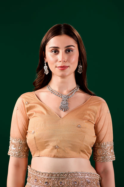 Kanyaari Kundan premium silk orange saree with intricate rose gold cutdana work and detailed border design.