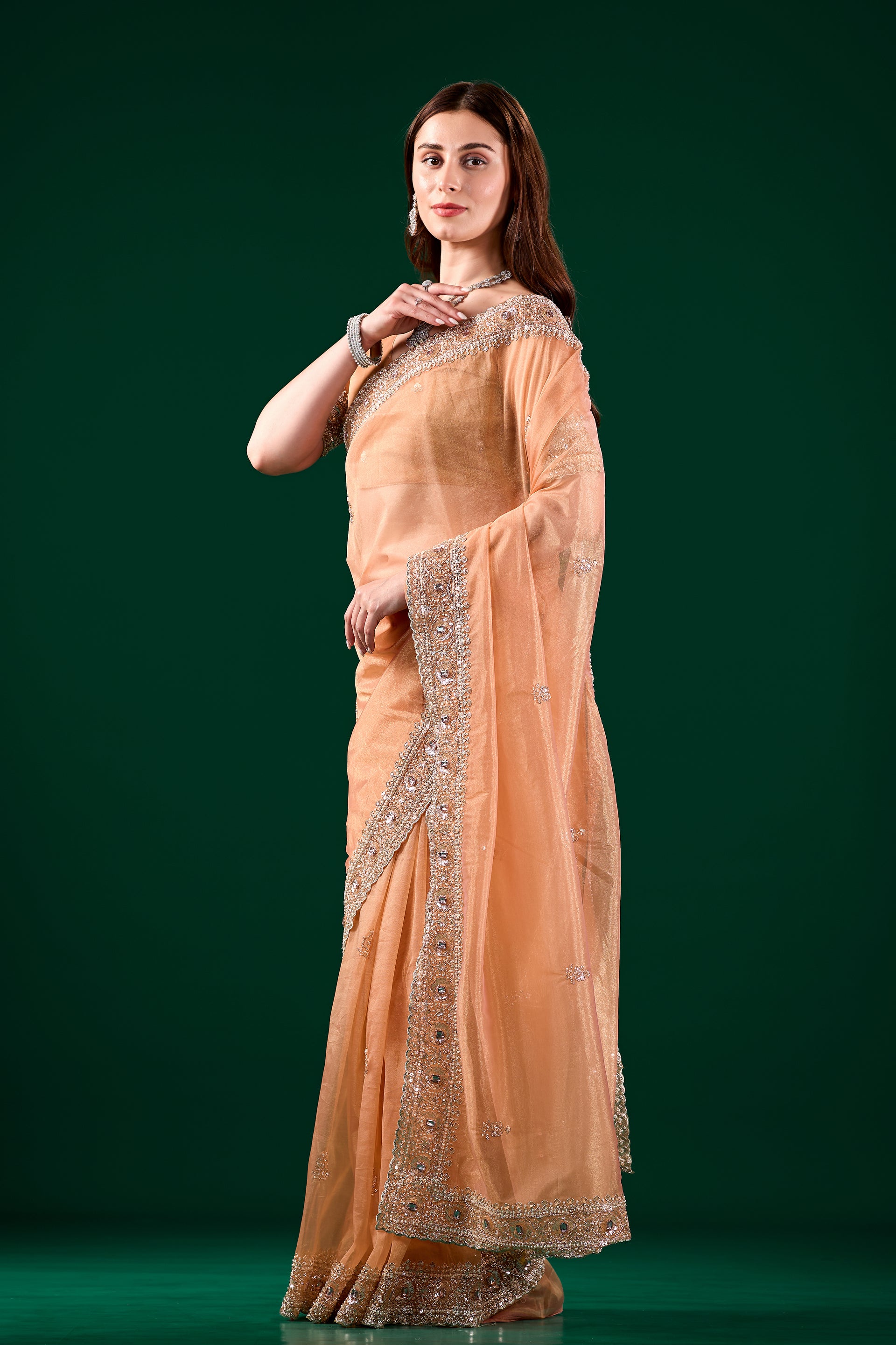 Kanyaari Kundan premium silk orange saree with intricate rose gold cutdana work and traditional drape.