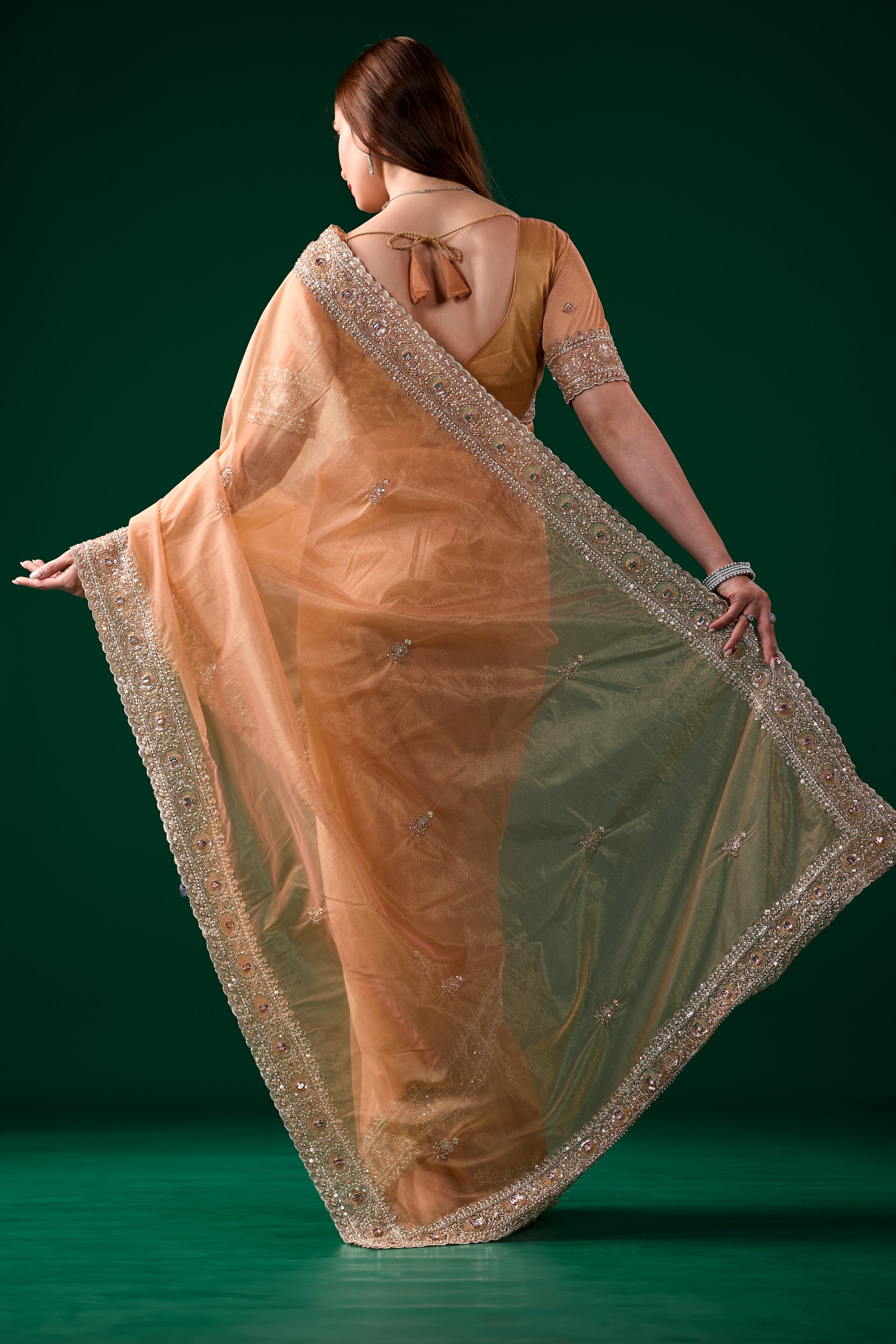 Kanyaari Kundan premium silk orange saree with intricate rose gold cutdana work and traditional drape.