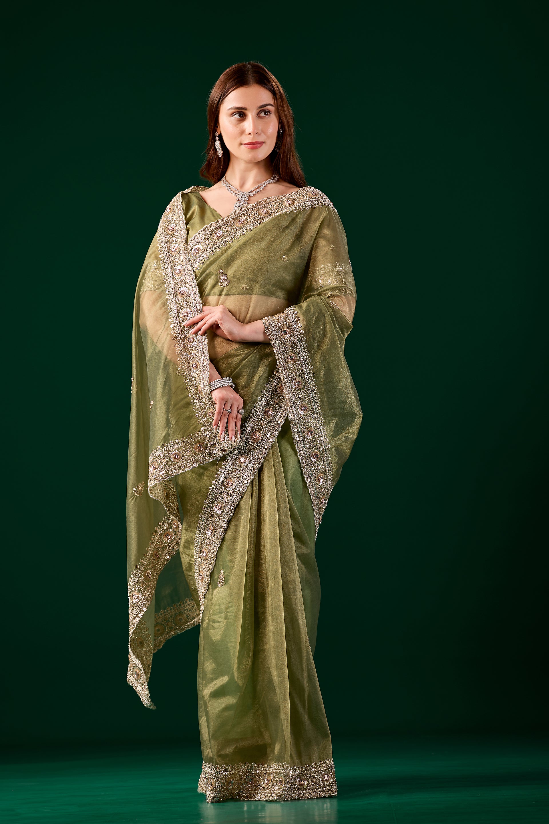 Green Kundan premium silk saree with rose gold cutdana work by Kanyaari, featuring intricate embroidery and elegant draping.