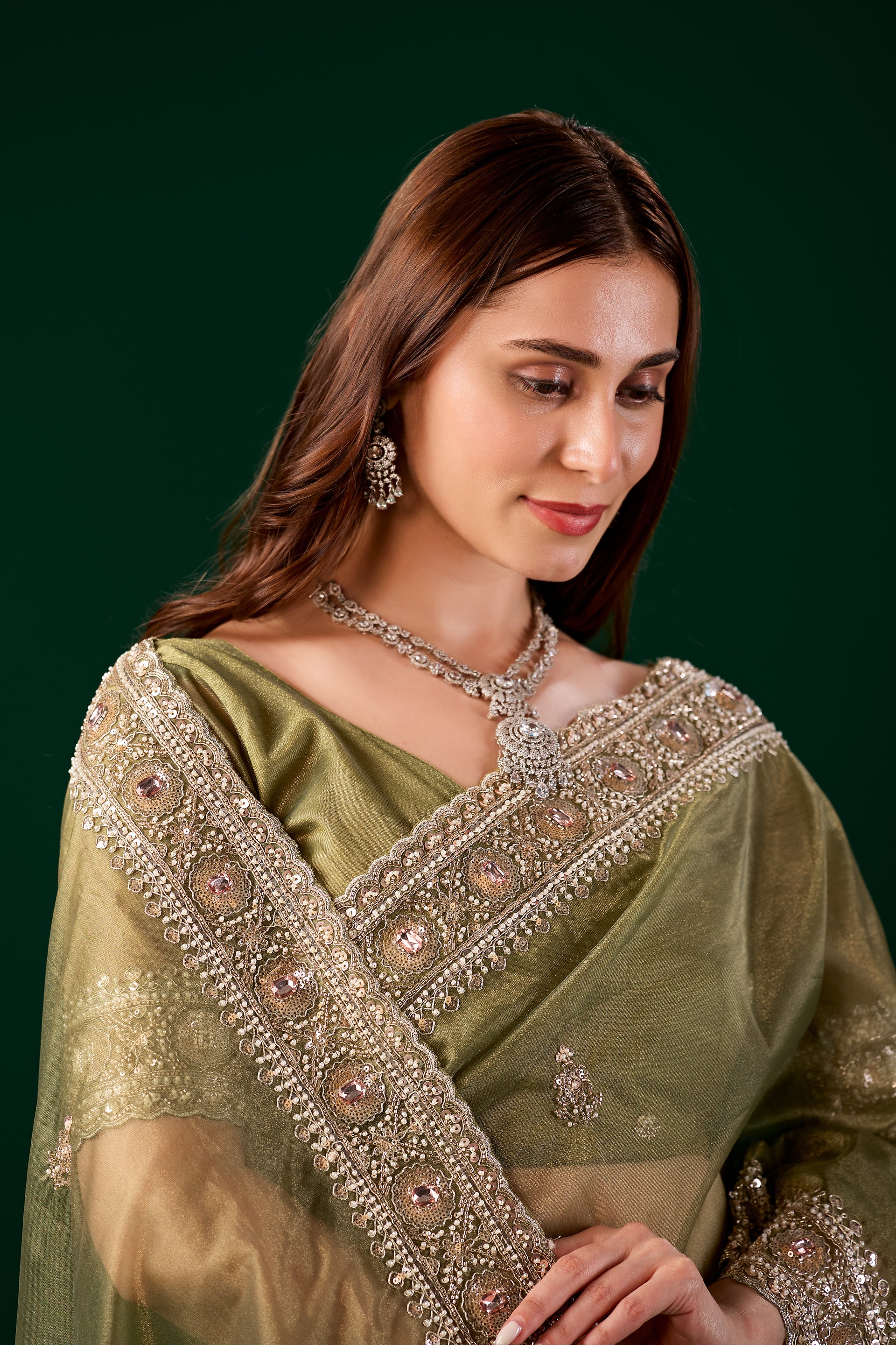 Kanyaari Kundan premium silk green saree with rose gold cutdana work, showcasing intricate embroidery and traditional craftsmanship.