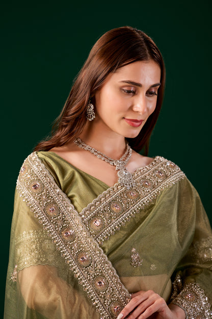 Kanyaari Kundan premium silk green saree with rose gold cutdana work, showcasing intricate embroidery and traditional craftsmanship.