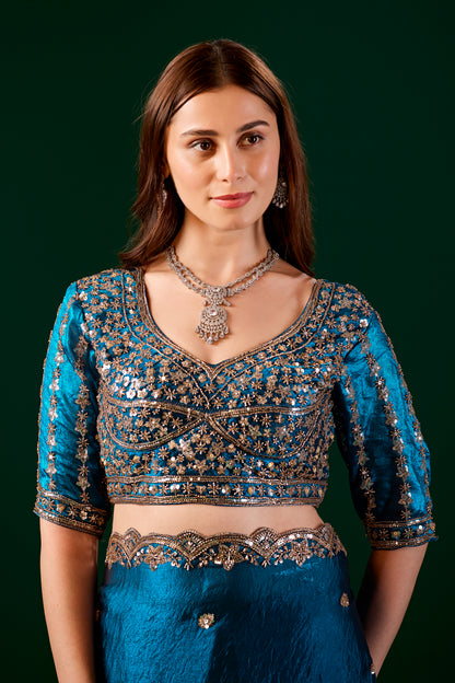 Blue Kanyaari saree with heavy fabric and intricate cutdana work, showcasing elegant traditional craftsmanship.