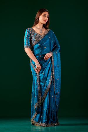 Blue Kanyaari saree with heavy fabric and intricate cutdana work, showcasing elegant traditional design and craftsmanship.