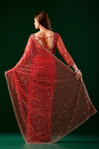 Red embroidered saree with heavy cutdana work and net fabric by Kanyaari, featuring intricate design and traditional style.