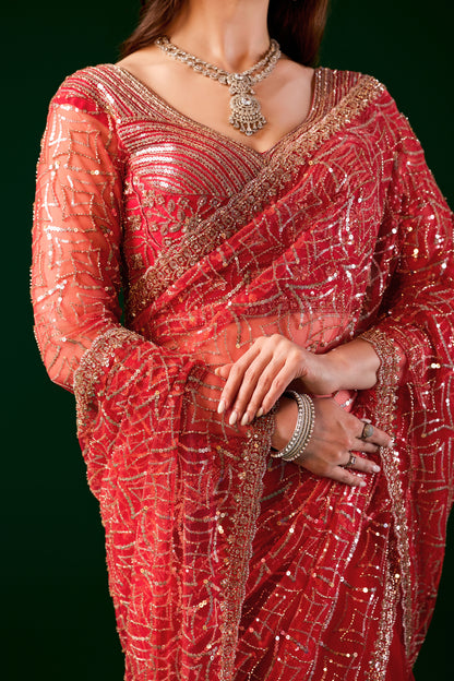 Red saree by Kanyaari featuring heavy cutdana embroidery and net fabric, styled with intricate embroidery details.