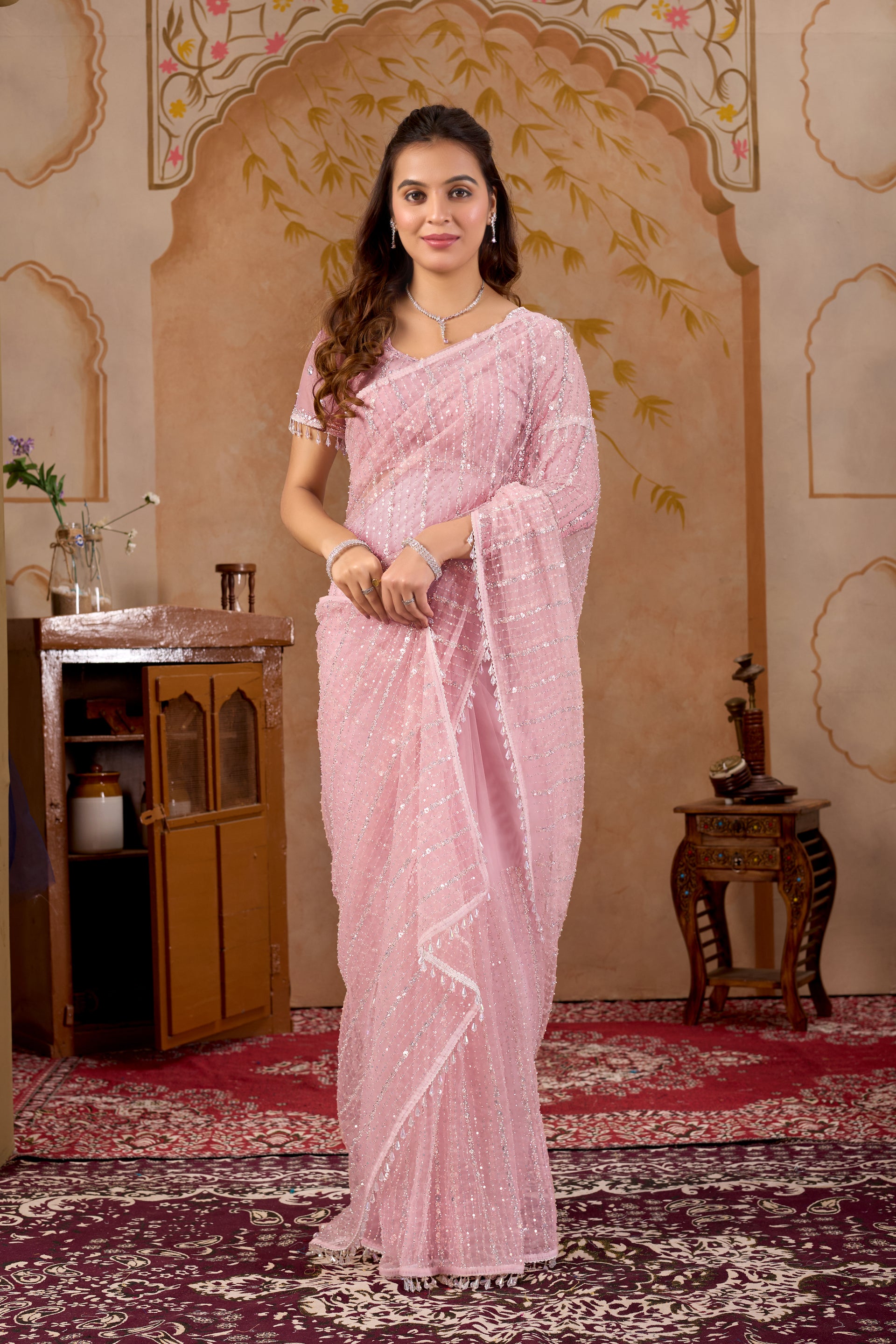Pink net handwork saree with unstitched blouse from Kanyaari, showcasing intricate embroidery and lightweight fabric.