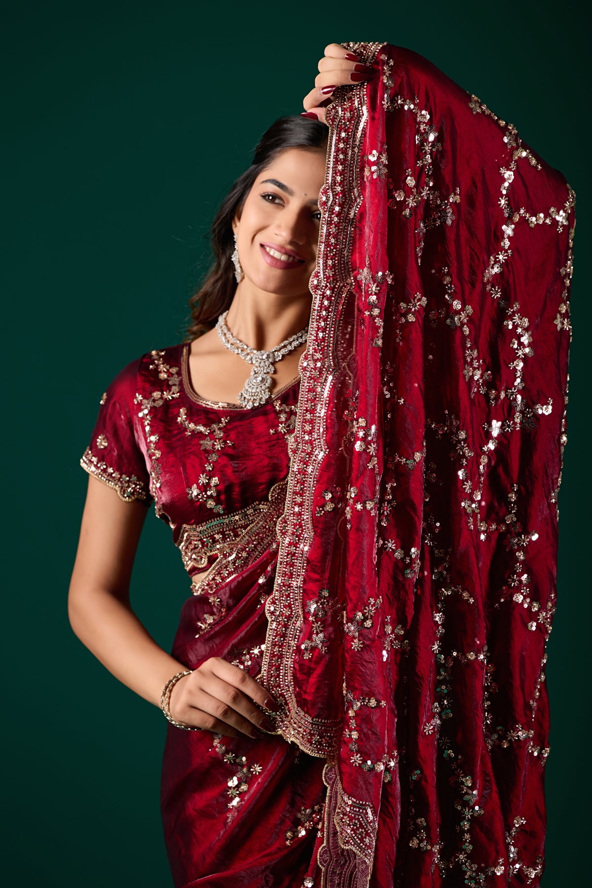 Nakhrali premium maroon silk saree by Kanyaari with rose gold cutdana work, intricate floral embroidery, and elegant drape.
