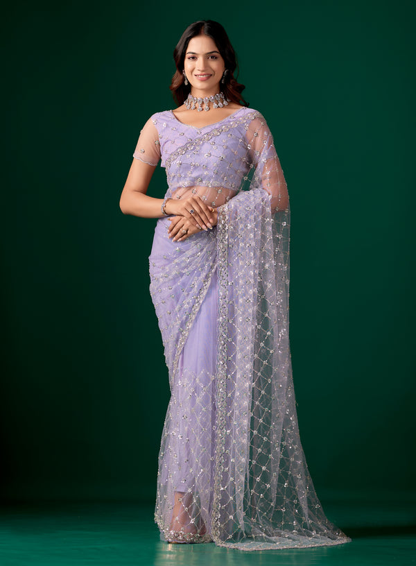 Purple net saree with cutdana work by Kanyaari, featuring intricate embroidery and stylish drape.