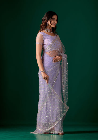 Kanyaari purple net saree with cross stylish design and intricate cutdana work, displayed on a mannequin.