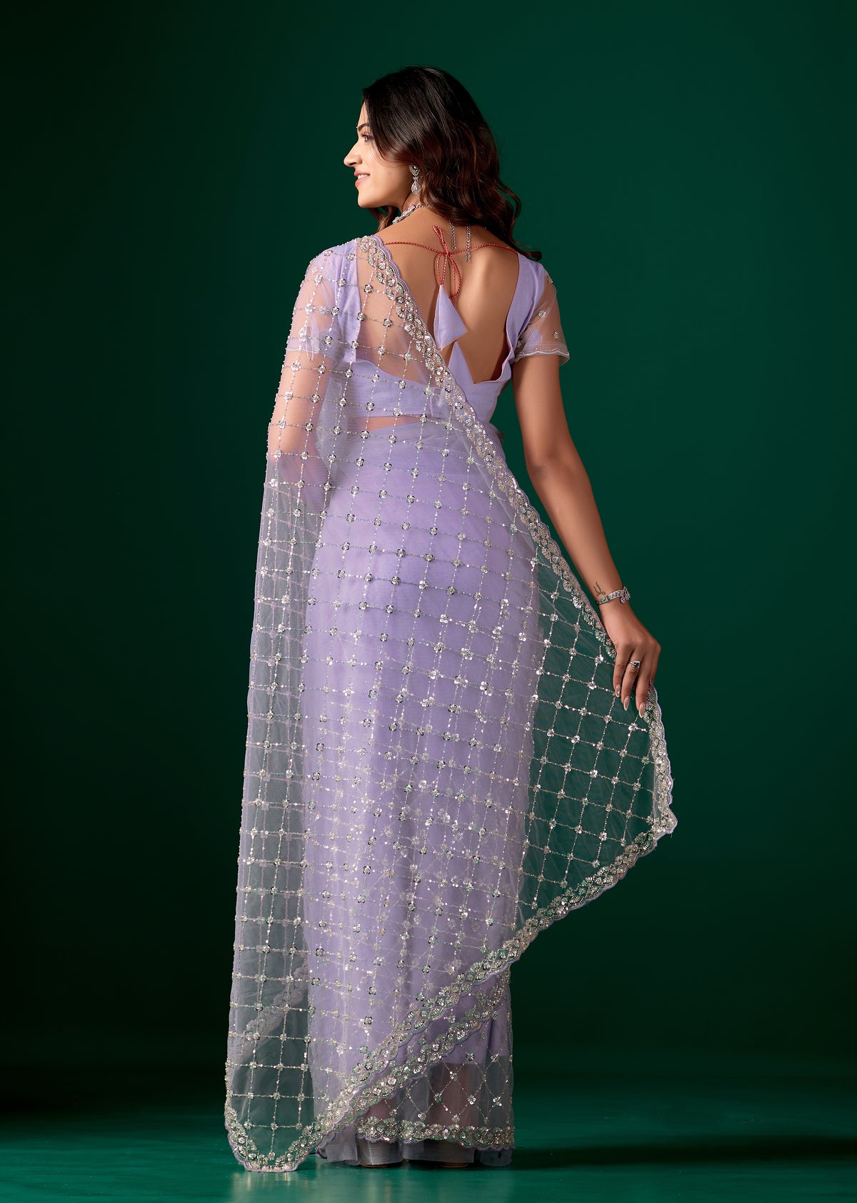 Purple net saree with cutdana work from Kanyaari, featuring intricate embroidery and stylish drape.