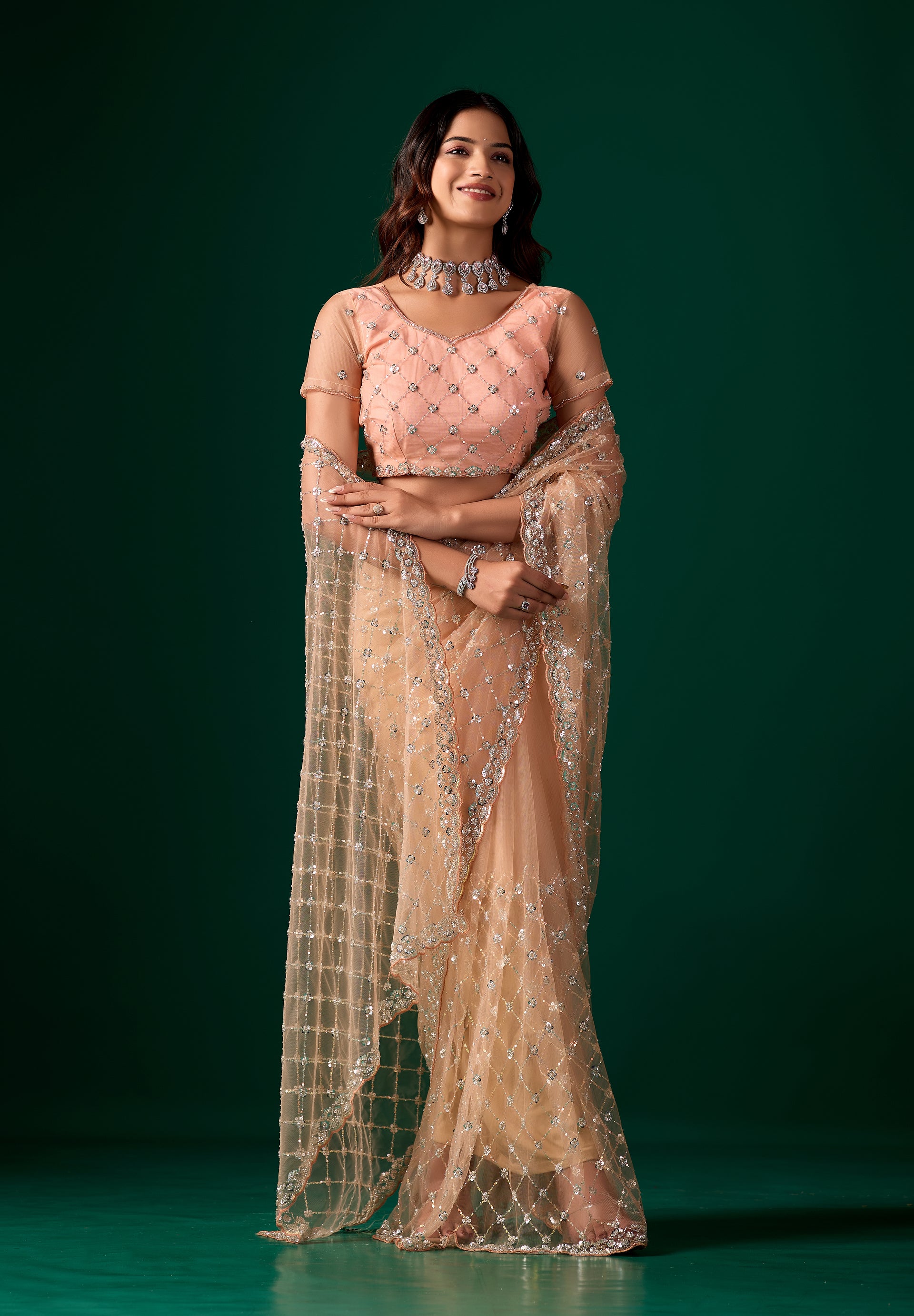 Orange net saree with cutdana work by Kanyaari, featuring intricate embroidery and stylish design for elegant traditional wear.