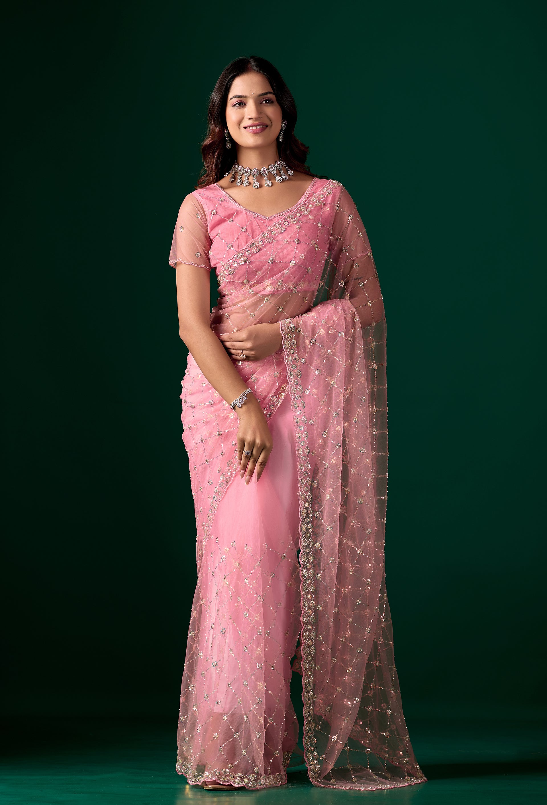 Pink party wear saree with intricate cutdana work from Kanyaari, featuring elegant drape and detailed embroidery.