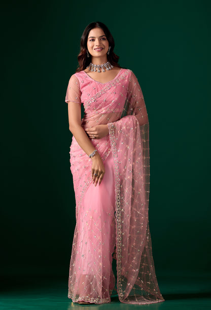 Pink party wear saree with intricate cutdana work from Kanyaari, featuring elegant drape and detailed embroidery.