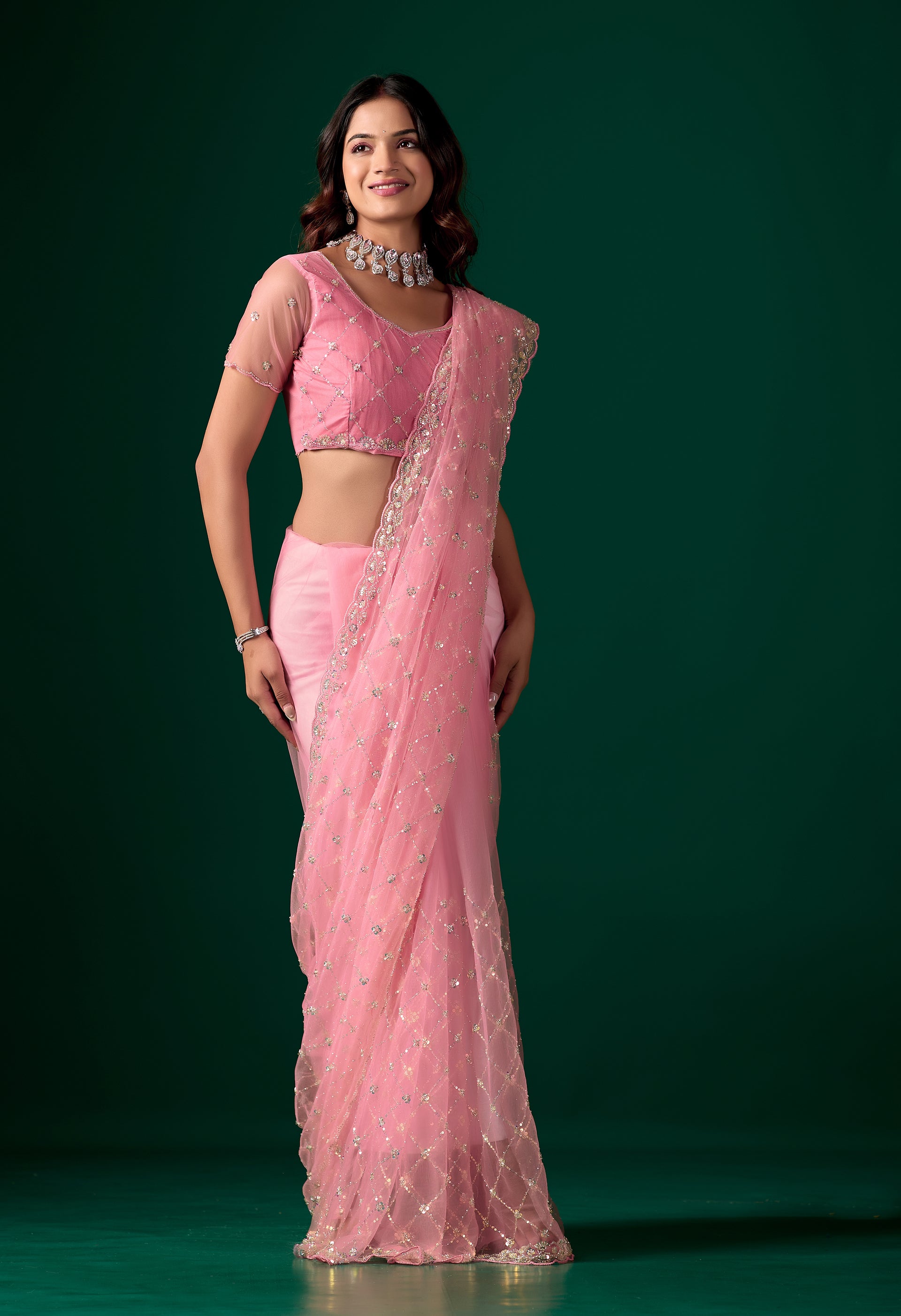 Pink party wear saree with intricate cutdana work from Kanyaari, featuring elegant drape and detailed embellishments.