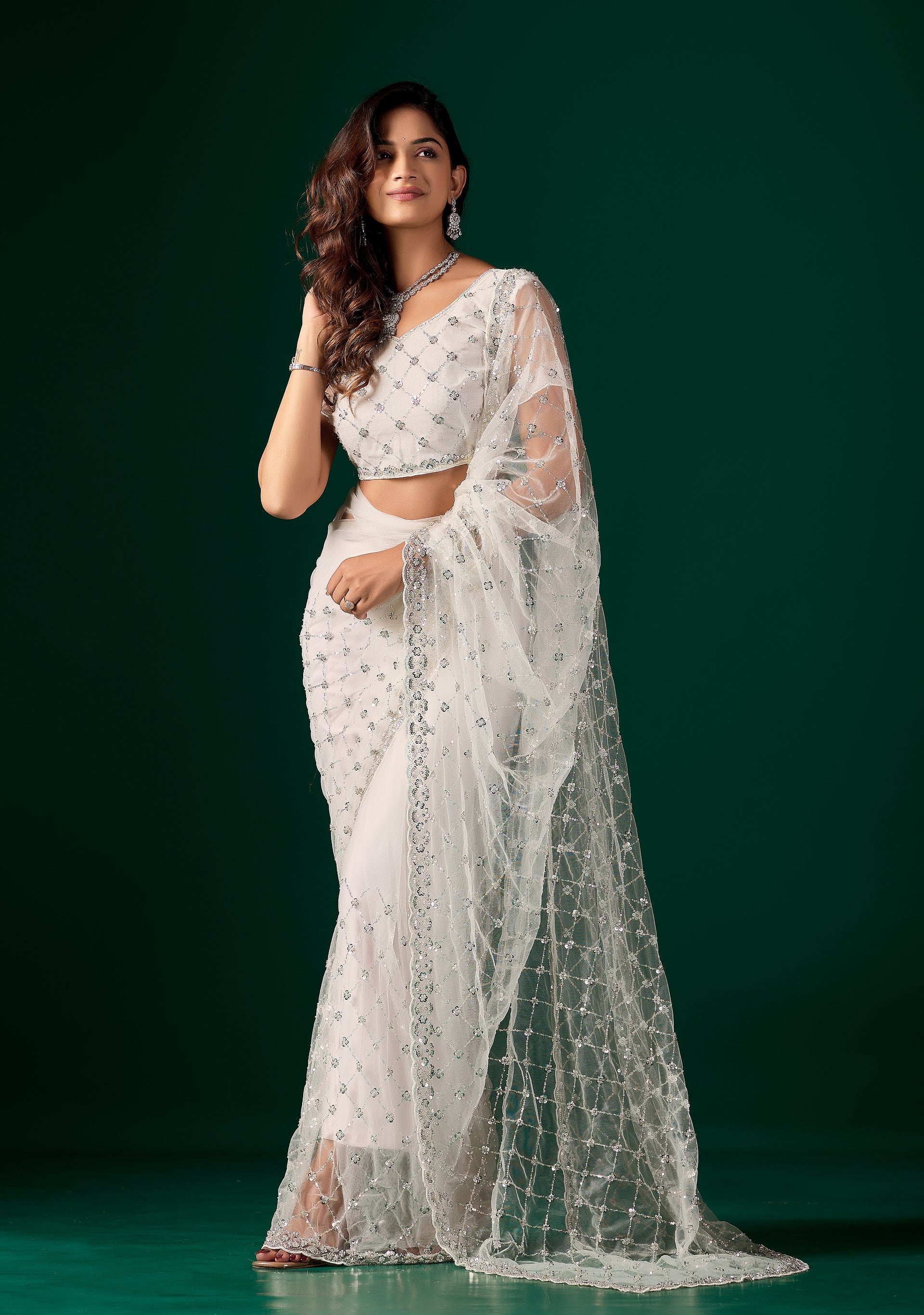 Kanyaari stylish white party wear saree with intricate cutdana and sequence work, draped elegantly for festive occasions.