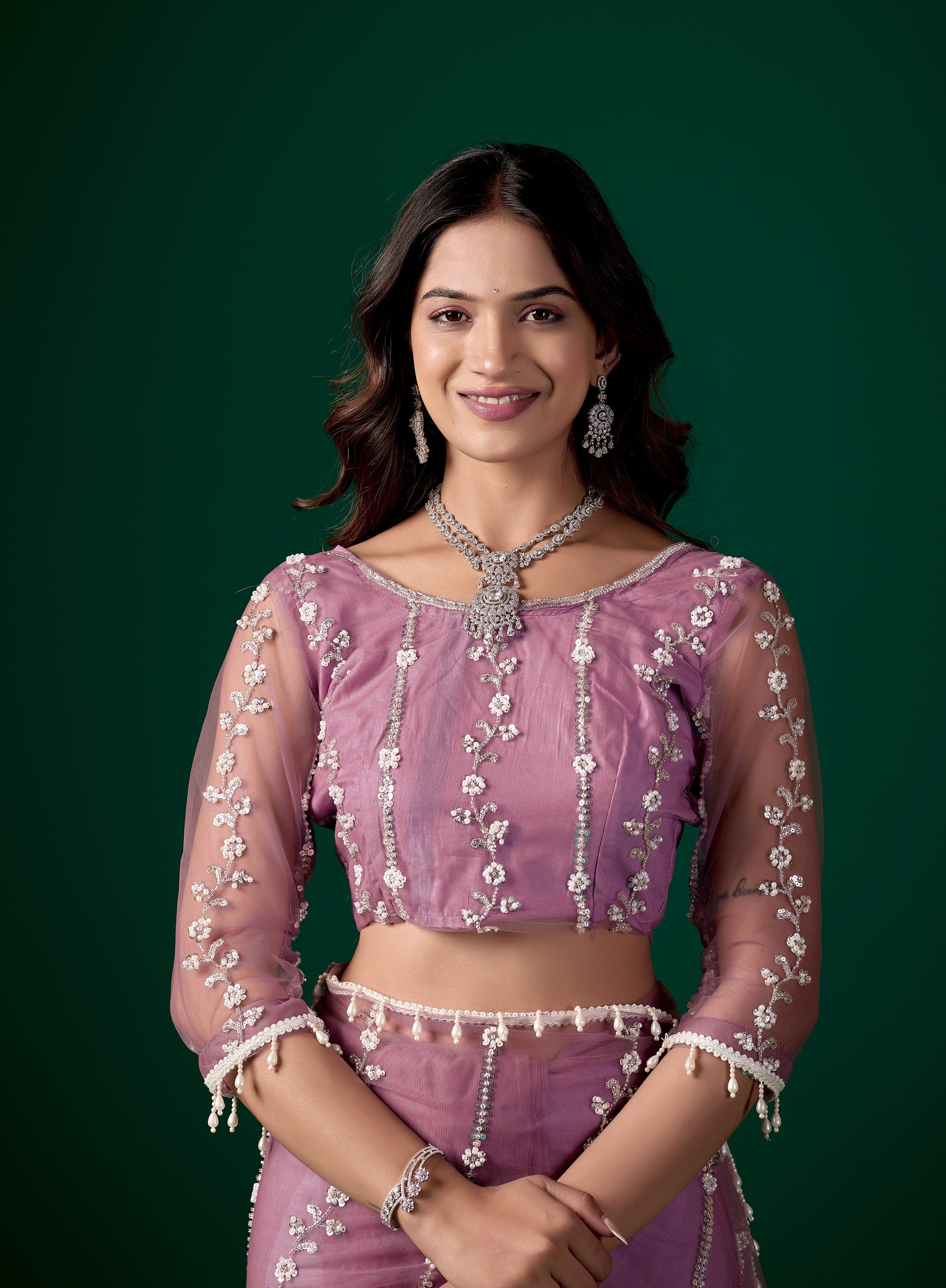 Kanyaari Tamannaah purple net saree with intricate cutdana work, showcasing elegant draping and detailed embroidery.